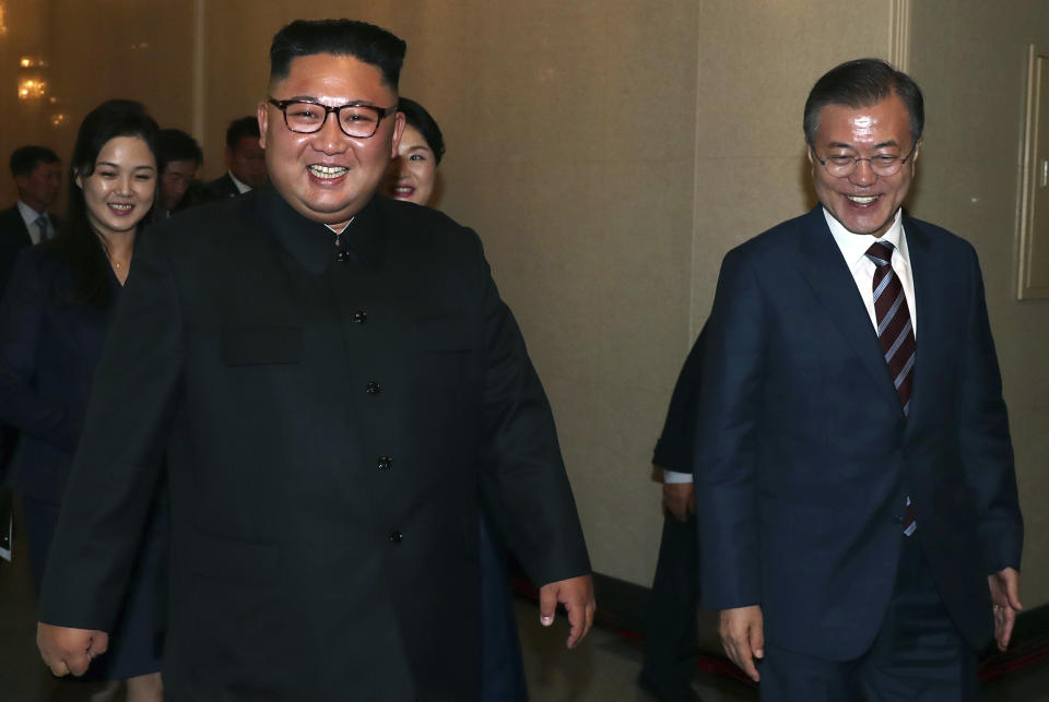 South Korean President Moon Jae-in, right, and North Korean leader Kim Jong Un leave the Pyongyang Grand Theatre in Pyongyang, North Korea, Tuesday, Sept. 18, 2018. President Moon Jae-in began his third summit with North Korean leader Kim Jong Un on Tuesday with possibly his hardest mission to date — brokering some kind of compromise to keep North Korea's talks with Washington from imploding and pushing ahead with his own plans to expand economic cooperation and bring a stable peace to the Korean Peninsula. (Pyongyang Press Corps Pool via AP)