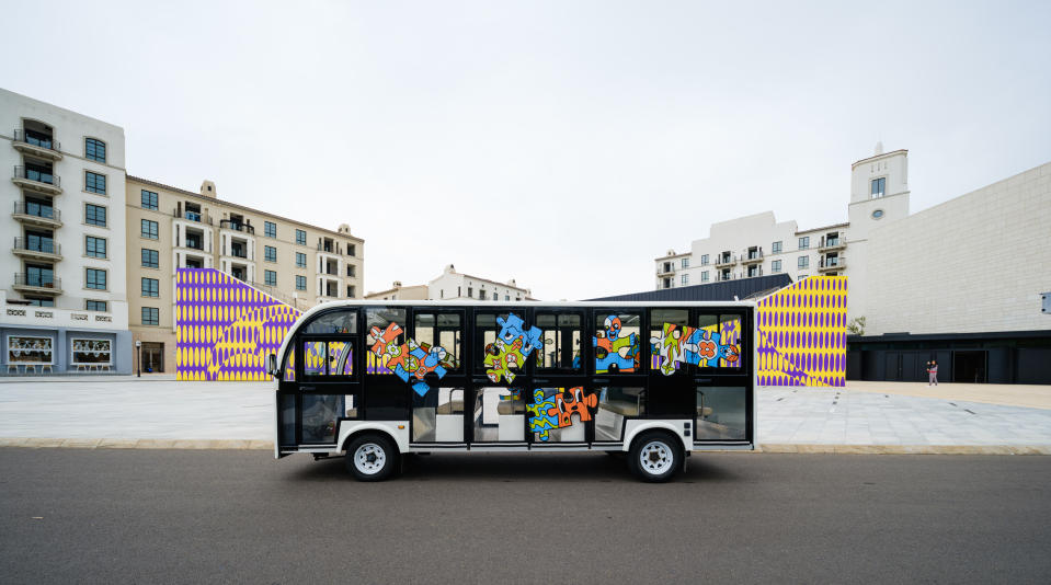 An Aranya community bus covered in Louis Vuitton graphics.