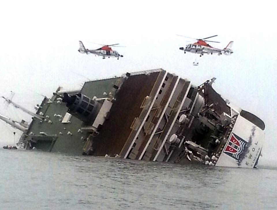 FILE - In this April 16, 2014 file photo, South Korean rescue helicopters fly over South Korean ferry Sewol, trying to rescue passengers from the ship in waters off Jindo, South Korea. Salvage workers are slowly pulling up the huge, corroded South Korean ferry above the sea surface Thursday, March 23, 2017, about three years after it sank on its routine voyage to a resort island, killing more than 300 people, mostly high school students. (Yonhap via AP, File)