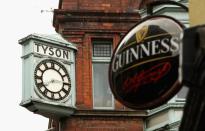 A clock is seen above a pub in Dublin. Guinness is Ireland's most recognisable brand of beer.