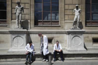 Models wait outside prior to the Thom Browne mens Spring-Summer 2020 fashion collection presented in Paris, Saturday, June 22 2019. (AP Photo/Michel Euler)