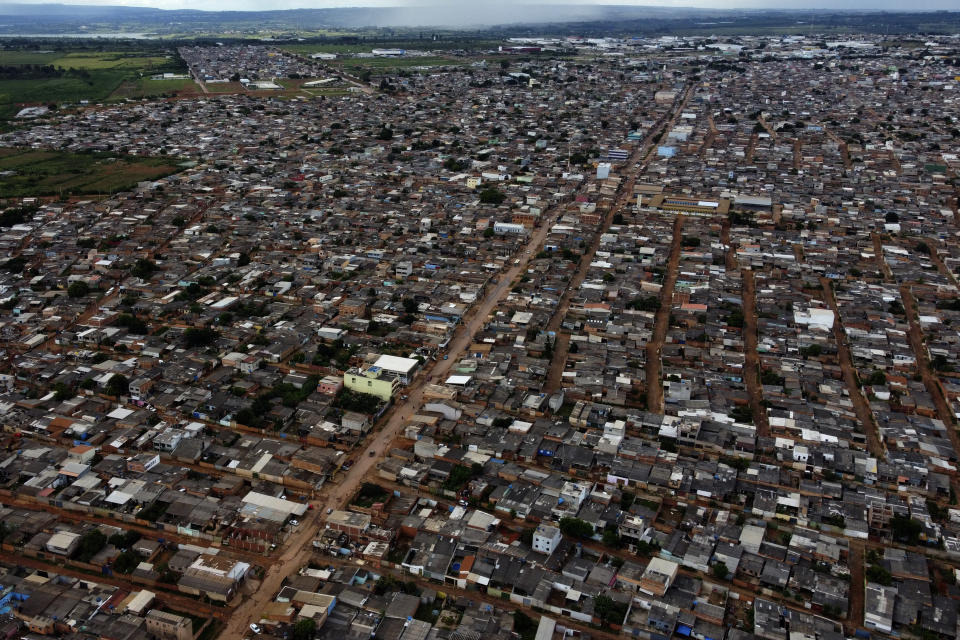 Streets are flooded by rain in the Sol Nascente favela of Brasilia, Brazil, Wednesday, March 22, 2023. The number of households in Sol Nascente, which means Rising Sun, has swelled 31% since 2010 to more than 32,000, surpassing the hillside Rocinha favela in Rio that had been Brazil’s most populous, according to preliminary data from the ongoing census. (AP Photo/Eraldo Peres)