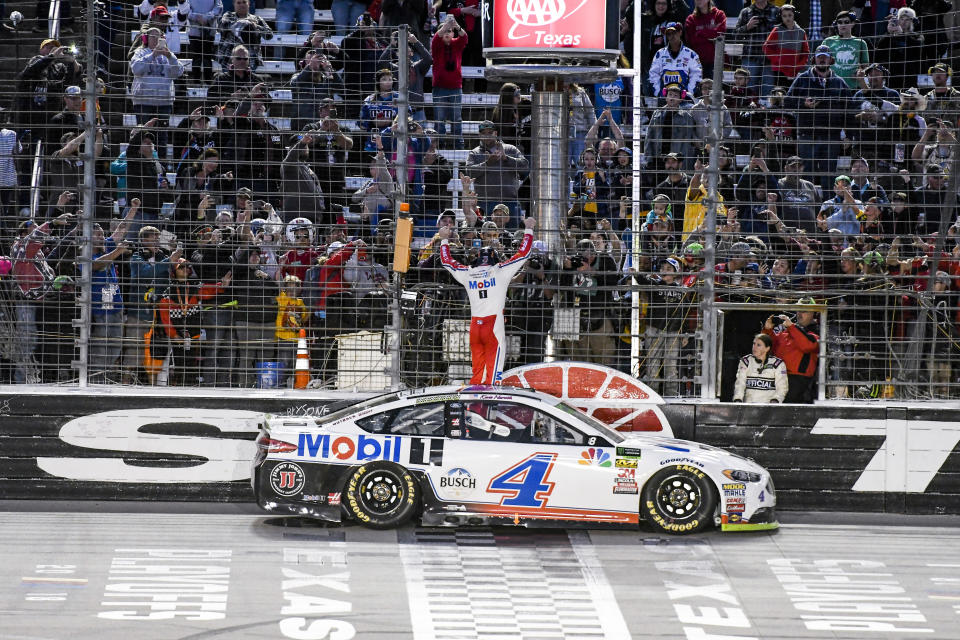 Kevin Harvick celebrates with fans after winning a NASCAR Cup auto race at Texas Motor Speedway, Sunday, Nov. 4, 2018, in Fort Worth, Texas. (AP Photo/Larry Papke)