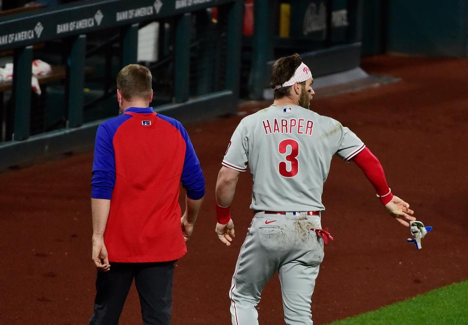 Bryce Harper walks off the field after being hit by a pitch against the Cardinals.