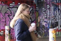 A woman walks past a mural depicting the image of George Floyd under railway arches at Waterloo Station, in London, Wednesday, April 21, 2021. After three weeks of testimony, the trial of the former police officer charged with killing George Floyd ended swiftly: barely over a day of jury deliberations, then just minutes for the verdicts to be read — guilty, guilty and guilty — and Derek Chauvin was handcuffed and taken away to prison. The guilty verdict in the George Floyd trial was not just America's victory. It signaled hope for those seeking racial justice and fighting police brutality across the Atlantic. (AP Photo/Alberto Pezzali)