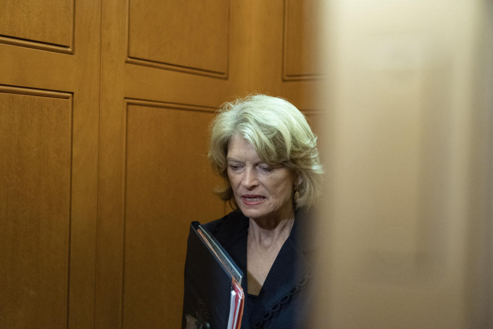 FILE - In this Oct. 7, 2021, file photo, Sen. Lisa Murkowski, R-Alaska, stands in an elevator as she departs, on Capitol Hill, in Washington. A man described as a "normal guy" who kept a low profile in his rural Alaska community faces charges he threatened to hire an assassin to kill the U.S. senator. Jay Allen Johnson was scheduled to be arraigned later Friday, Oct. 8, 2021, on charges related to phone threats authorities say he made against Murkowski. Johnson was arrested earlier in the week and was being held in a Fairbanks jail ahead of the federal court hearing. (AP Photo/Alex Brandon, File)