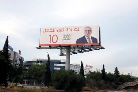 An election campaign billboard depicts Tunisian Minister of Defense and presidential candidate Abdelkarim Zbidi in Tunis