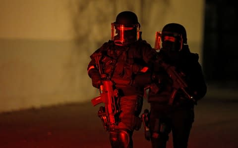 French special police forces secure an area during a police operation in the Meinau district after the deadly shooting in Strasbourg - Credit: Reuters