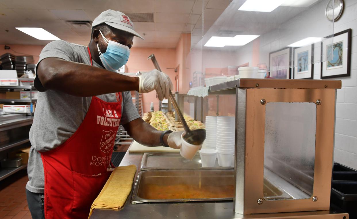 Alpha Bangoura, kitchen supervisor at the Salvation Army of Sarasota County, prepares cups of vegetable soup to be served with a hot lunch for clients at the shelter on 10th St. in Sarasota. The Salvation Army of Sarasota County, like many other nonprofit organizations in the area, is struggling with staffing shortages.
