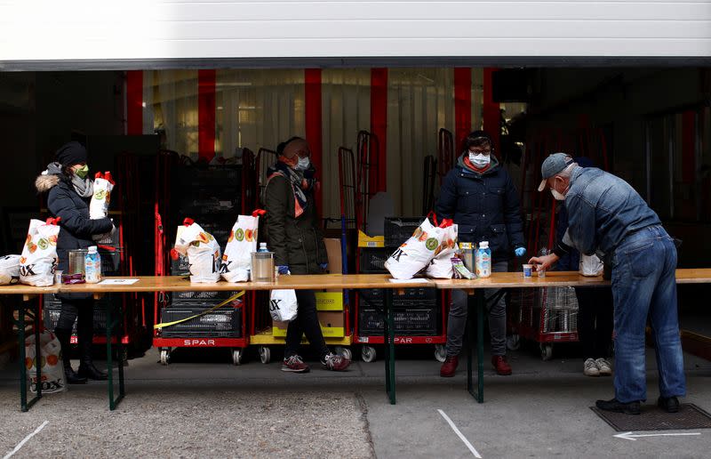 Volunteers of Caritas prepare bags with food during a food distribution for the needy as the spread of the coronavirus disease (COVID-19) continues in Vienna