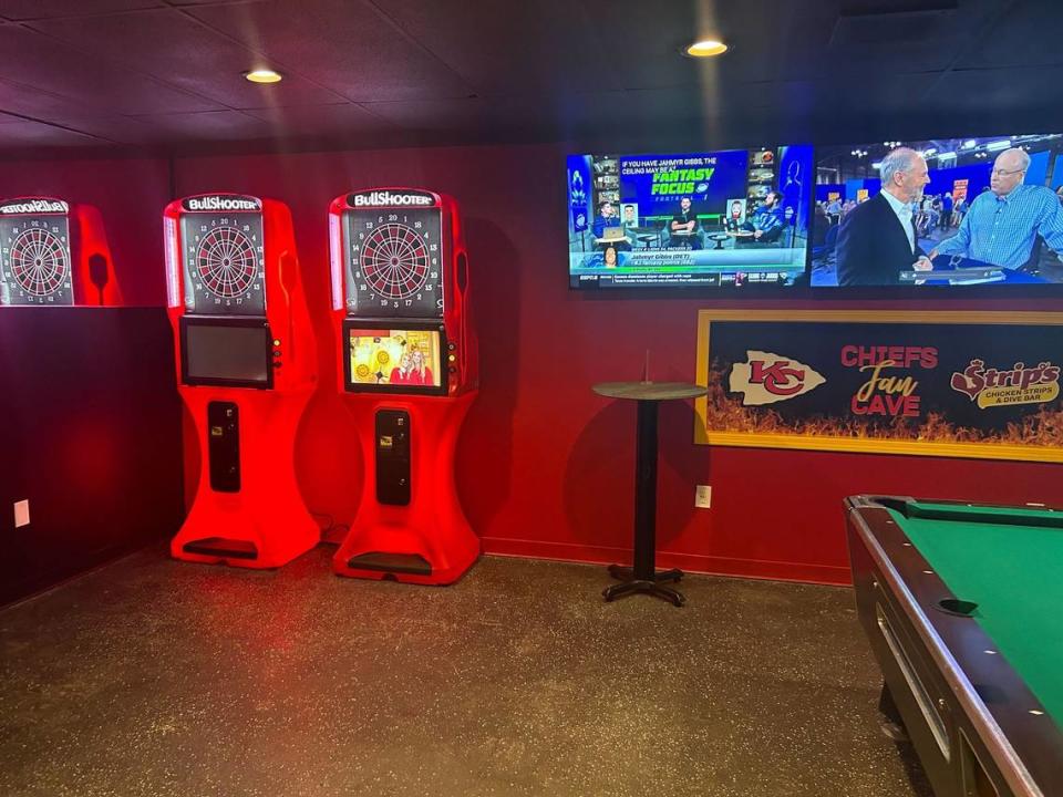 A Chiefs “fan cave” sits at the back of a new dive bar and chicken shop in Merriam, complete with games, pool and several screens.