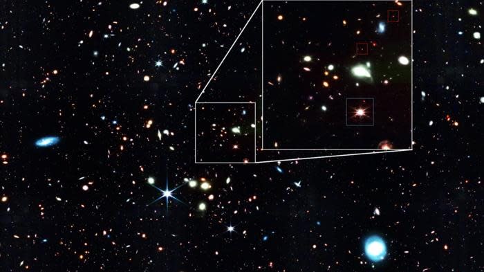  An image of a starry section of space; some little red sparkles are pointed out. 