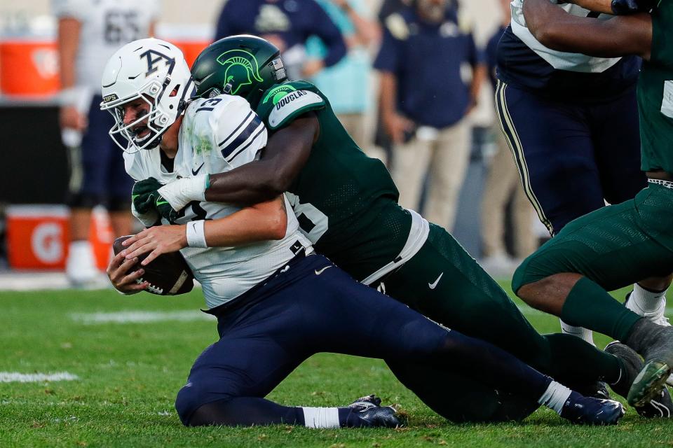 Michigan State defensive end Zion Young (18) sacks Akron quarterback Jeff Undercuffler Jr. (13) during the second half at Spartan Stadium in East Lansing on Saturday, Sept. 10, 2022.