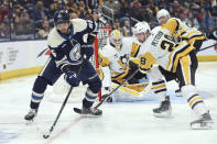 Columbus Blue Jackets forward Kirill Marchenko (86) controls the puck in front of Pittsburgh Penguins defenseman Marcus Pettersson during the second period of an NHL hockey game in Columbus, Ohio, Saturday, March 30, 2024. (AP Photo/Paul Vernon)