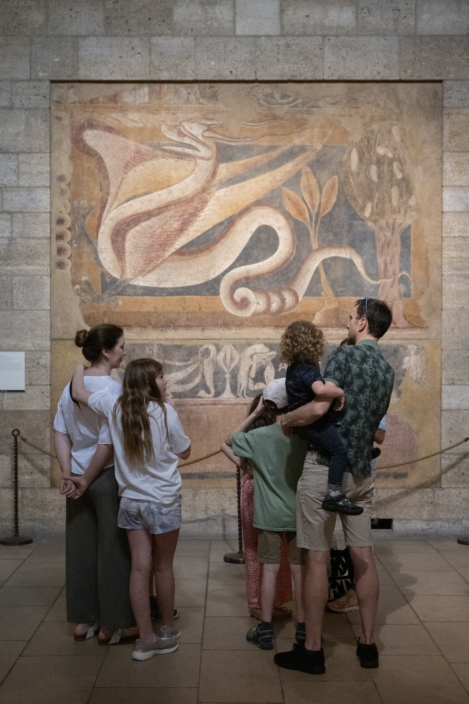 a group of people looking at a map on a wall