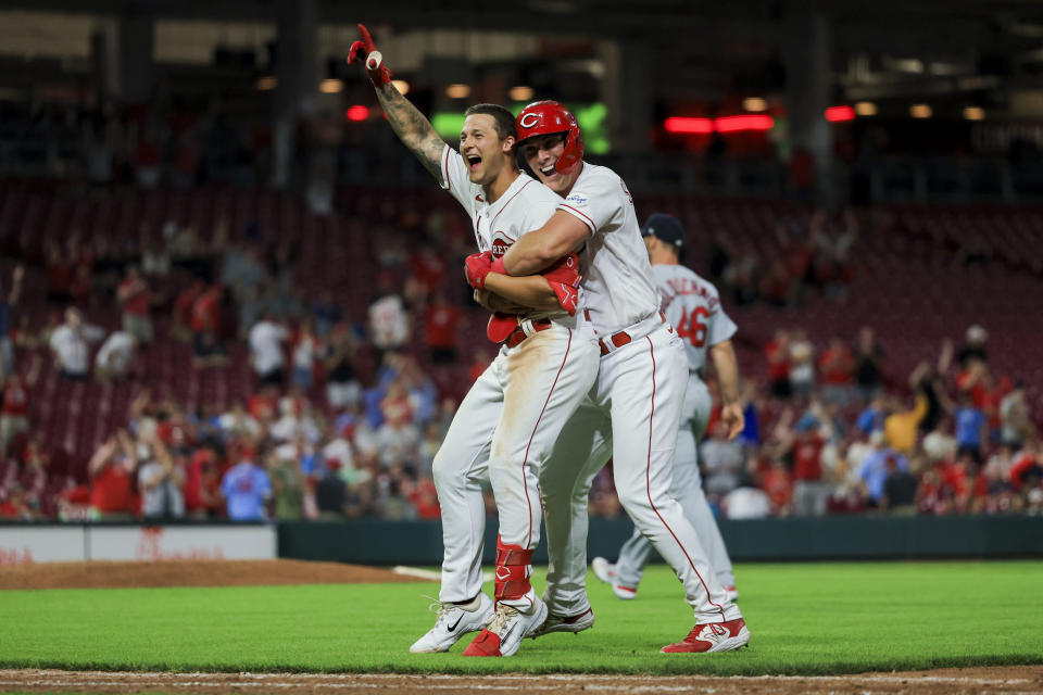 Cincinnati Reds' Nick Senzel, left, celebrates with Tyler Stephenson after hitting a walkoff sacrifice fly during the 10th inning of a baseball game against the St. Louis Cardinals in Cincinnati, Monday, May 22, 2023. (AP Photo/Aaron Doster)