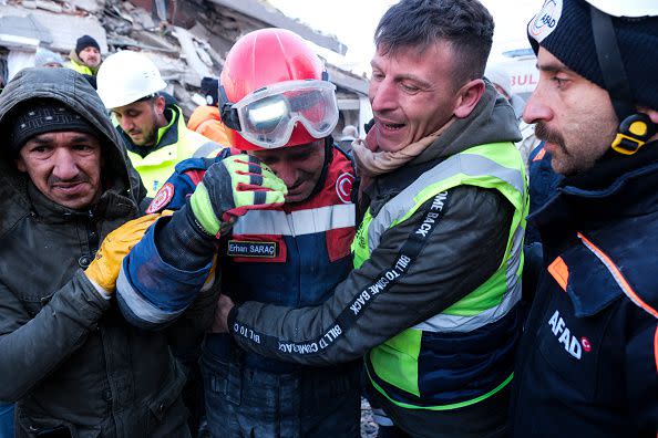 ELBISTAN, TURKEY - FEBRUARY 09: Fireman Erhan Sarac and other rescue team members celebrate each other just after a successful evacuation on February 9, 2023 in Elbistan, Turkey. A 7.8-magnitude earthquake hit near Gaziantep, Turkey, in the early hours of Monday, followed by another 7.5-magnitude tremor just after midday. The quakes caused widespread destruction in southern Turkey and northern Syria and were felt in nearby countries. (Photo by Mehmet Kacmaz/Getty Images)