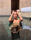 <p>The model goes topless while posing in the pool.</p>