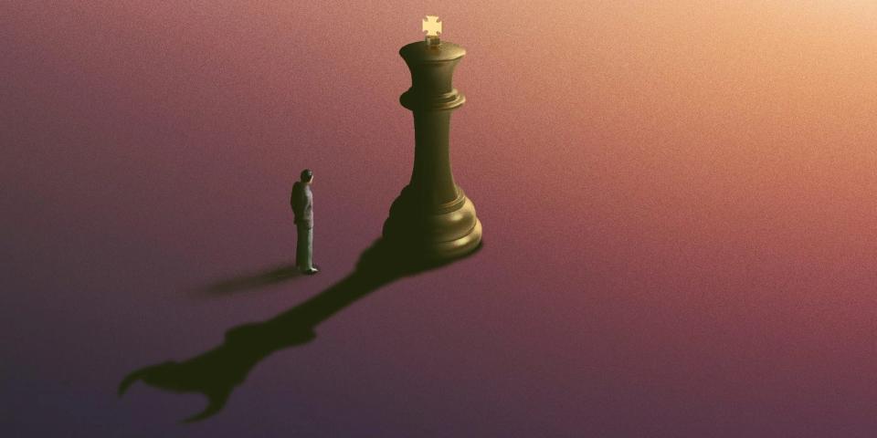 Person standing in the shadow of a chess piece