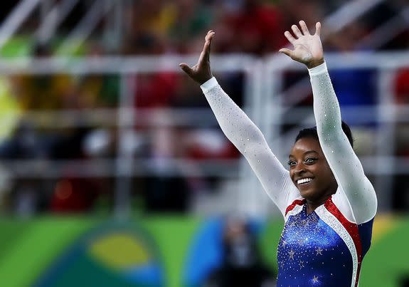 RIO DE JANEIRO, BRAZIL - AUGUST 11:  Simone Biles of the United States waves to fans after competing on the floor during the Women's Individual All Around Final on Day 6 of the 2016 Rio Olympics at Rio Olympic Arena on August 11, 2016 in Rio de Janeiro, Brazil.  (Photo by Elsa/Getty Images)