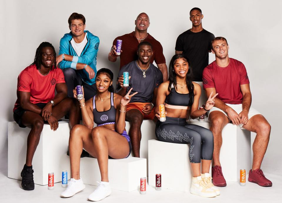 Georgia tight end Brock Bowers (far right in front) joined by Dwayne "The Rock" Johnson (center back row) and six other athletes for ZOA Energy drink photo shoot.