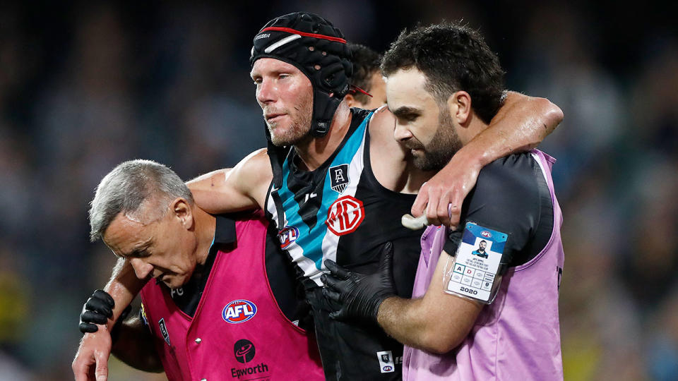 Seen here, Brad Ebert is helped off the field for Port Adelaide against Richmond in the 2020 AFL finals.