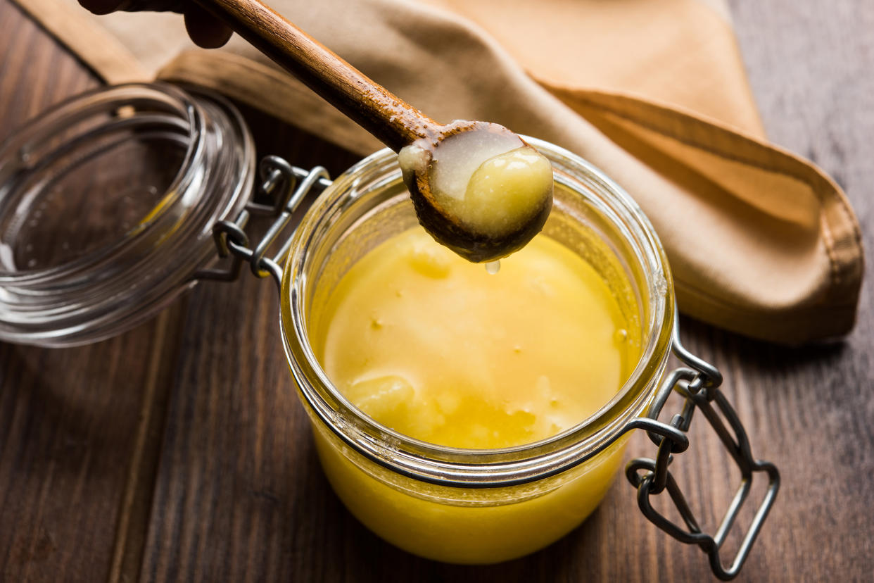 Desi Pure Ghee or clarified butter in glass or Copper container with spoon, selective focus (subodhsathe / Getty Images/iStockphoto)