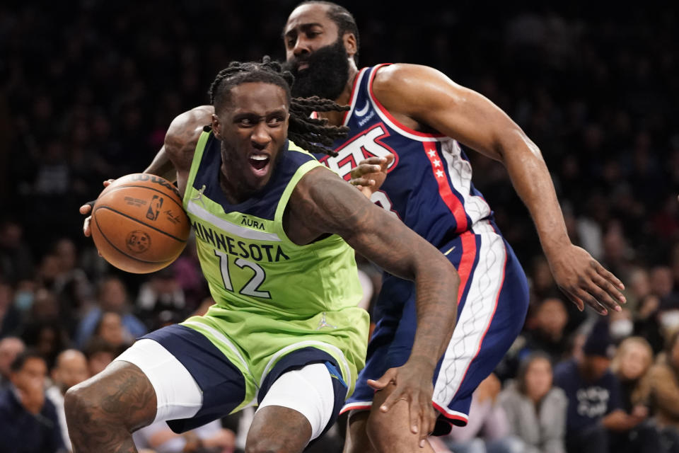 Minnesota Timberwolves forward Taurean Prince (12) drives against Brooklyn Nets guard James Harden during the first half of an NBA basketball game Friday, Dec. 3, 2021, in New York. (AP Photo/Mary Altaffer)