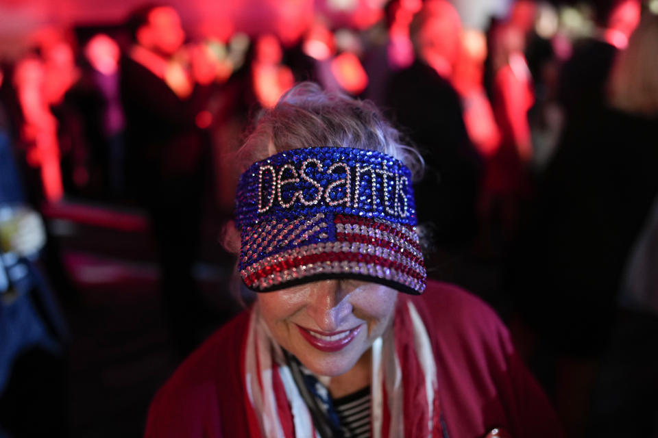 FILE - A woman arrives before Incumbent Republican Gov. Ron DeSantis speaks to supporters during an election night party in Tampa, Fla., on Nov. 8, 2022. DeSantis has emerged as a rival of former President Donald Trump and likely has his eyes set on the White House for the 2024 election. (AP Photo/Rebecca Blackwell, File)