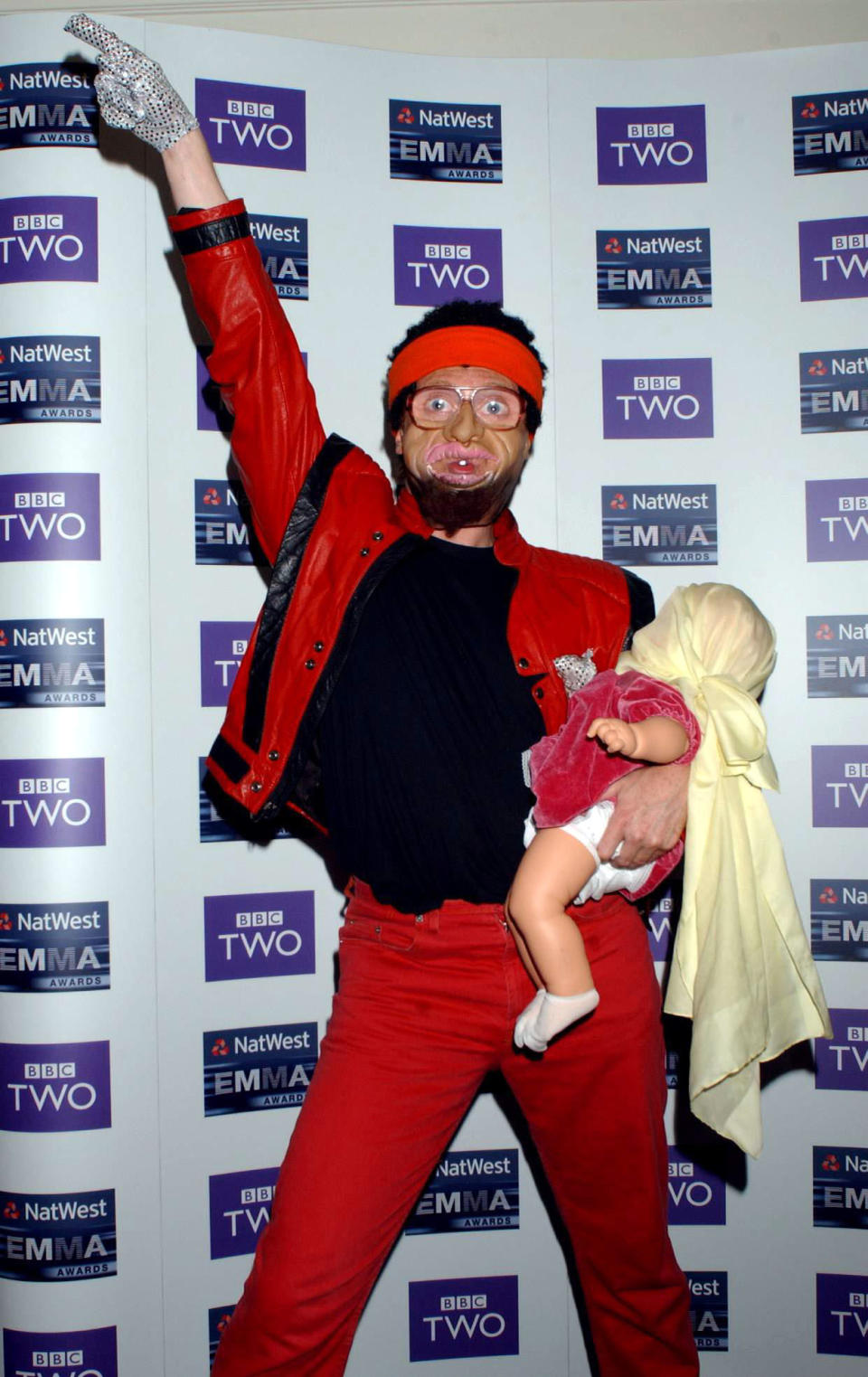 Comedian Avid Merrion, star of Channel 4's Bo Selecta, impersonates Michael Jackson during the 2003 NatWest EMMA (Ethnic Multicultural Media Academy) Awards, held at the Grosvenor House Hotel on Park Lane, central London.   (Photo by Yui Mok - PA Images/PA Images via Getty Images)