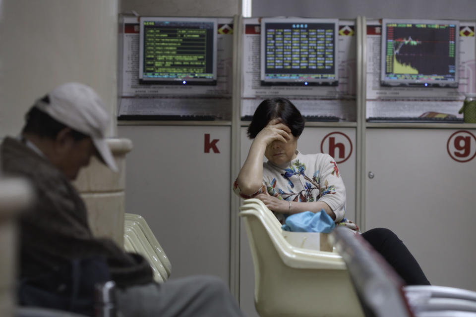 Investors rest at a brokerage in Beijing on Wednesday, Oct. 9, 2019. Shares slipped in Asia on Wednesday as tensions between the U.S. and China flared ahead of talks aimed at resolving the trade war between the world's two biggest economies. (AP Photo/Ng Han Guan)