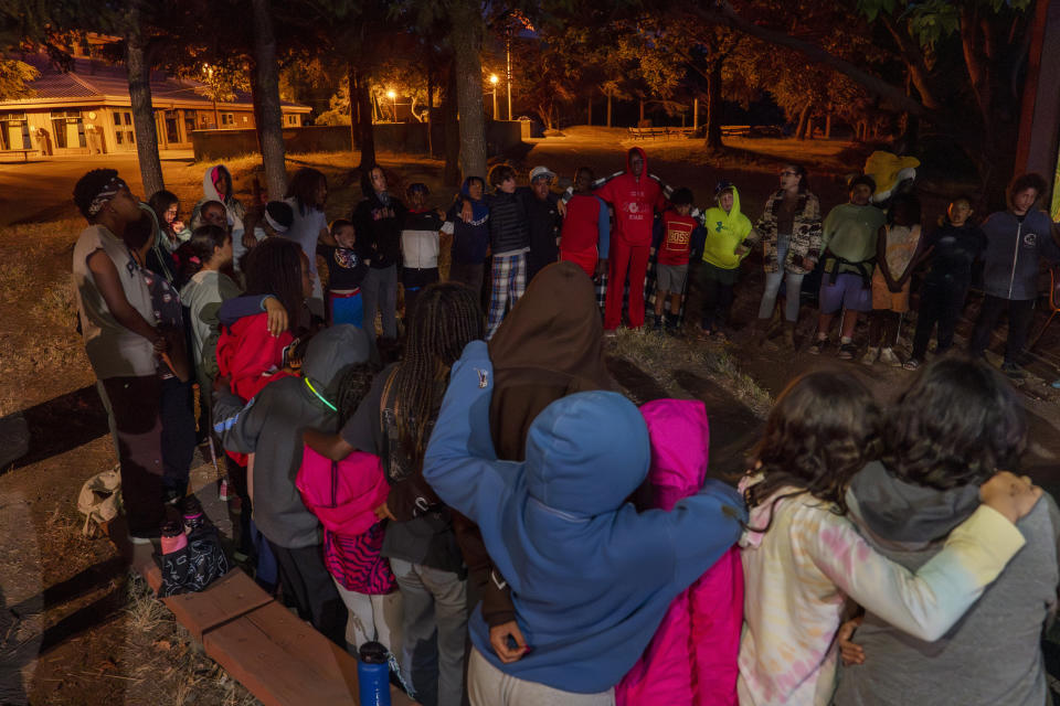 Campers sing the Hebrew Hashkiveinu prayer to say goodnight during Camp Be'chol Lashon, a sleepaway camp for Jewish children of color, Friday, July 28, 2023, in Petaluma, Calif., at Walker Creek Ranch. (AP Photo/Jacquelyn Martin)