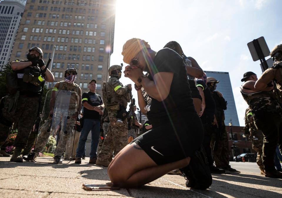 The Not F..king Around coalition came to Louisville in support of racial justice while the 3% Militia also was in town. Louisville police kept the two groups apart with barricades. Sonoyia Largent, of Fayetteville, NC. Prayed on the sidewalk beside the 3 % group. July 25, 2020.