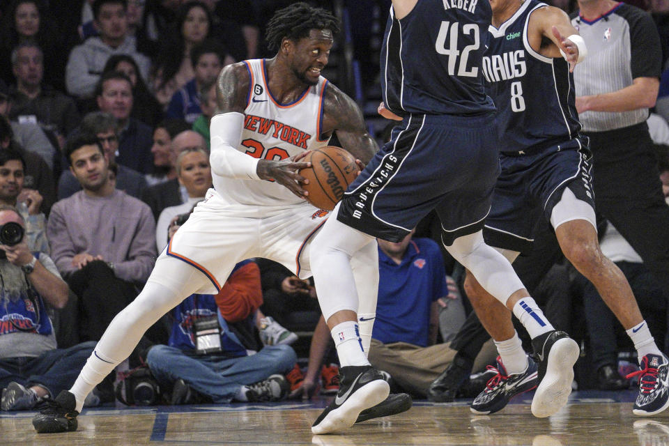 New York Knicks forward Julius Randle, looks for room to move as Dallas Mavericks defenders Josh Green, center, and Maxi Kleber, right, press during the first quarter of an NBA basketball game, Saturday, Dec. 3, 2022, in New York. (AP Photo/Bebeto Matthews)