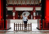 A woman wearing a protective face mask walks amid the coronavirus disease (COVID-19) outbreak, in Tokyo