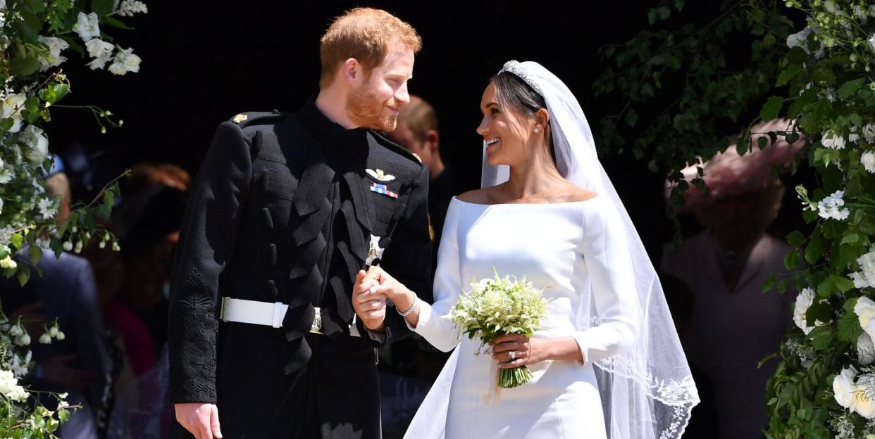 topshot   britains prince harry, duke of sussex and his wife meghan, duchess of sussex emerge from the west door of st georges chapel, windsor castle, in windsor, on may 19, 2018 after their wedding ceremony photo by ben stansall  various sources  afp        photo credit should read ben stansallafp via getty images