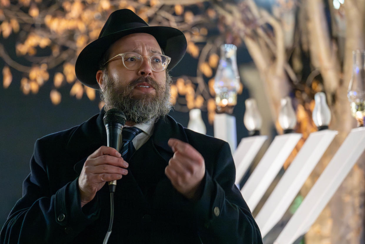 Rabbi Mendel, of Chabad Lubavitch of Doylestown, leads the Hanukkah celebration with the menorah lighting at the Shops of Valley Square in Warrington on Thursday night. Festivities featured songs, a bubble show, a gelt drop and traditional treats.