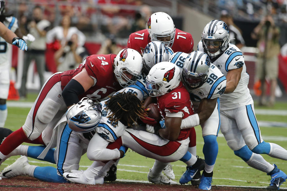 FILE - In this Sunday, Sept. 22, 2019, file photo, Arizona Cardinals' David Johnson (31) is stopped by the Carolina Panthers defense during an NFL football game in Glendale, Ariz. You can take that "any given Sunday" bromide and toss it out with some of Case Keenum's interceptions. So far in 2019, there is a Grand Canyon of separation between the contenders and everybody else. (AP Photo/Rick Scuteri, File)