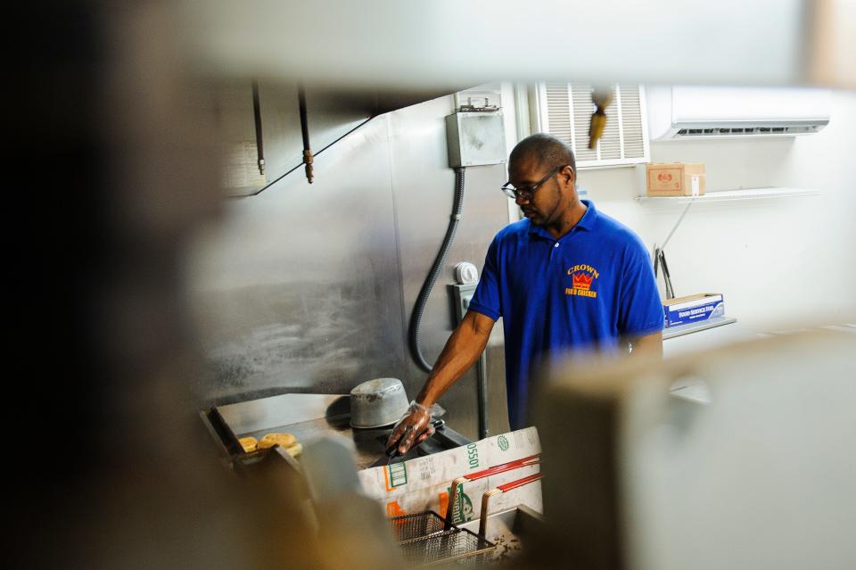 Josh Carroll grills hamburgers at Crown Fried Chicken in 2016 on Murchison Road in Fayetteville. 