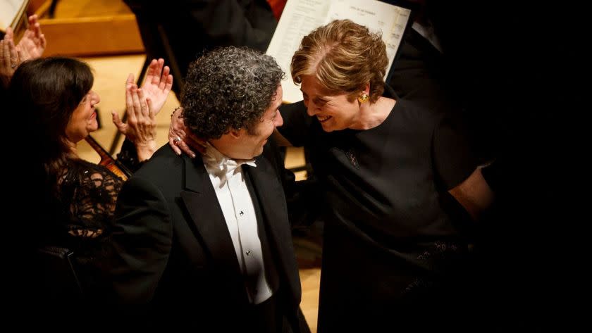 Outgoing L.A. Phil president Deborah Borda and conductor Gustavo Dudamel share a moment as she is ho