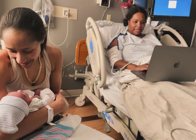 <p>Courtesy of Tamiah Brevard-Rodriguez</p> (From L-R) Alyza Brevard-Rodriguez, holding baby Enzo while Tamiah Brevard-Rodriguez preps to defend her dissertation.