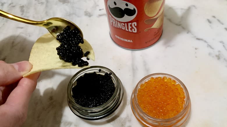 scooping caviar on Pringles chip