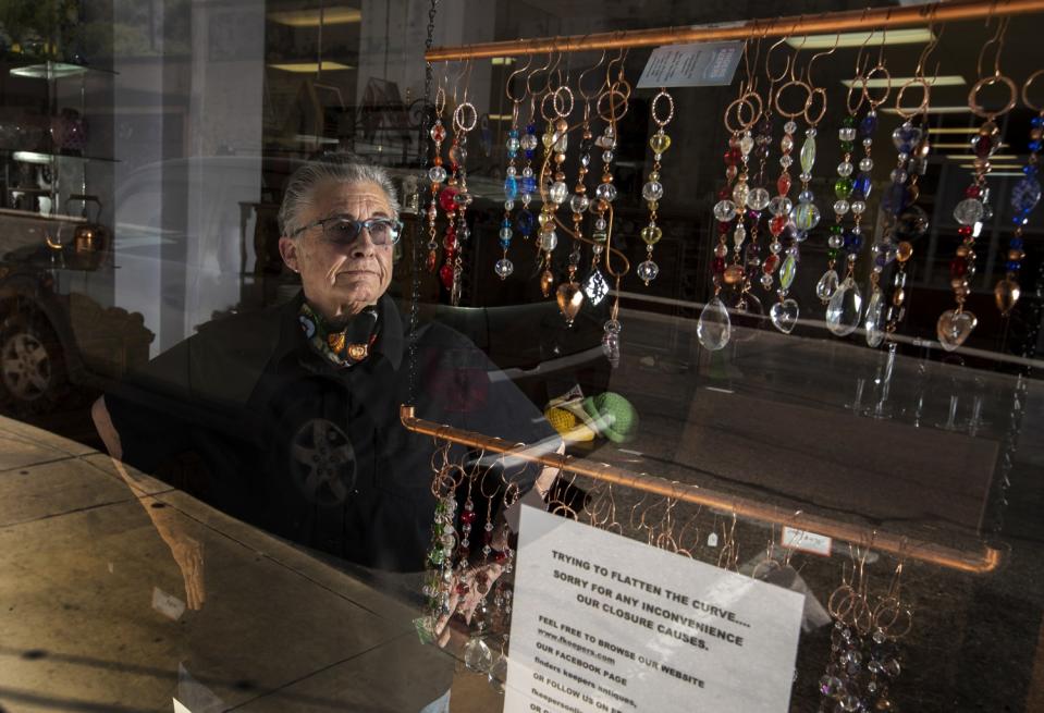 Finders Keepers co-owner Kathy Sowden stands in the window of her Main Street antique and gift shop.