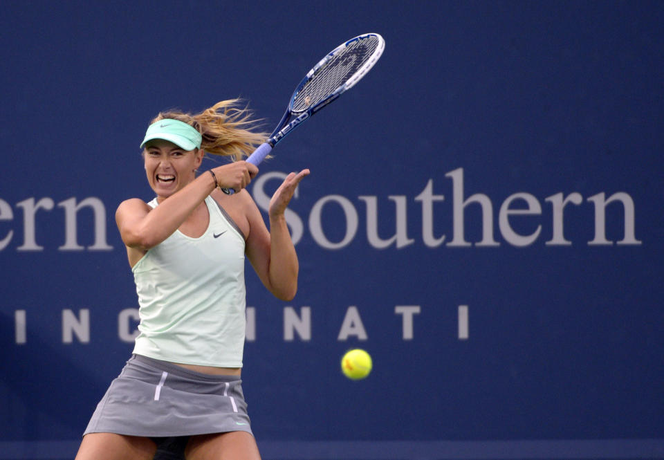 Maria Sharapova, from Russia, serves during a match against Sloane Stephens, from the United States, at the Western & Southern Open tennis tournament, Tuesday, August 13, 2013, in Mason, Ohio. (AP Photo/Michael E. Keating)