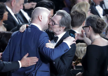 Actor Gary Oldman (R) kisses members of the Oscar-winning make-up team for "Darkest Hour." REUTERS/Lucas Jackson