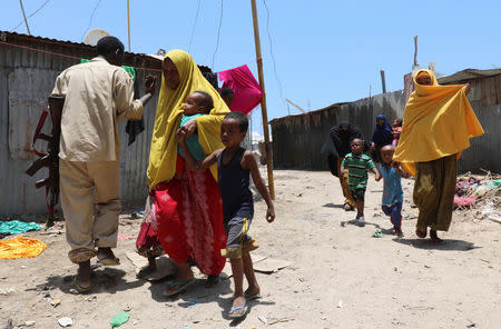 Civilians evacuate from the scene of a suicide explosion after al-Shabaab militia stormed a government building in Mogadishu, Somalia March 23, 2019. REUTERS/Feisal Omar