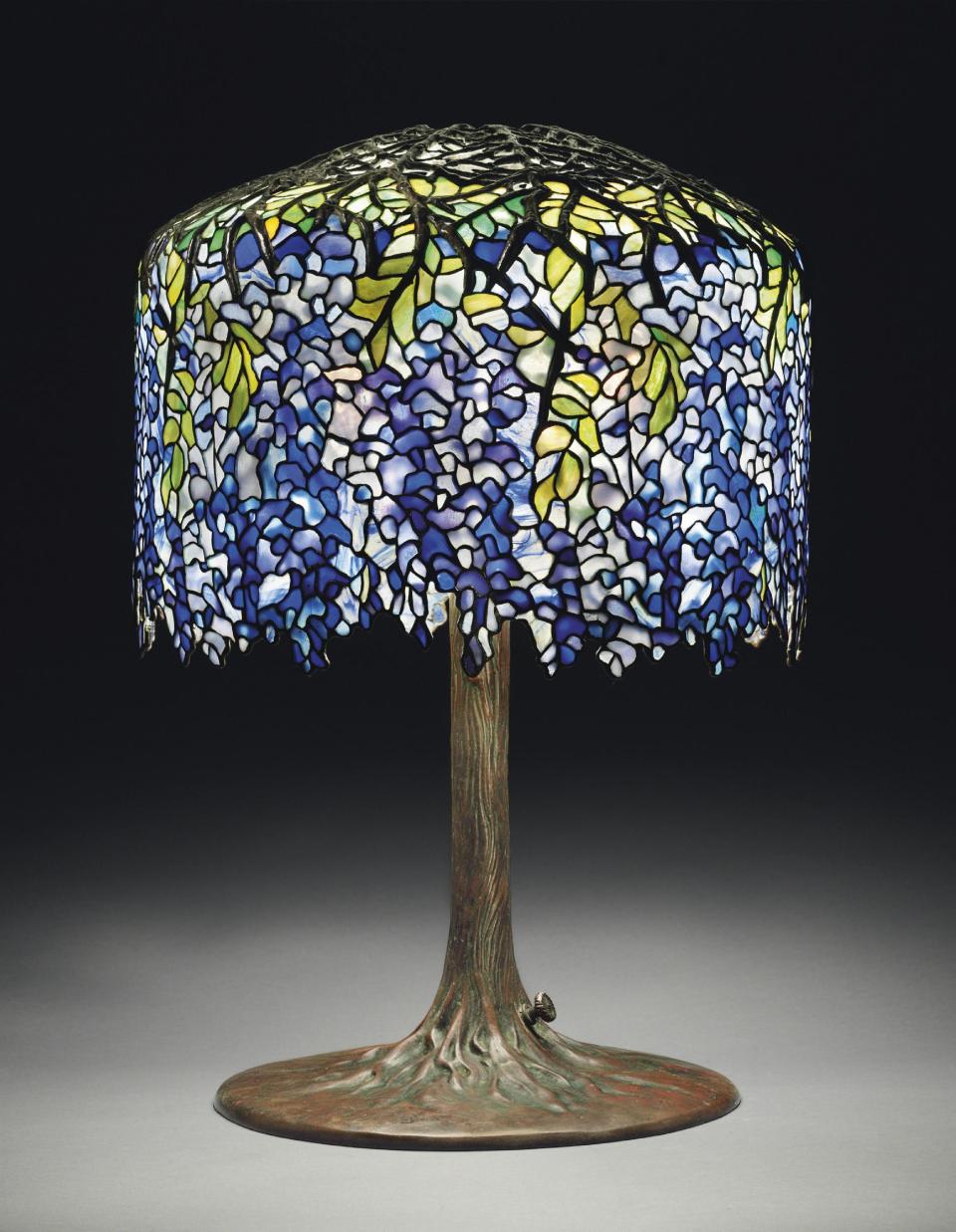 This undated photo provided by Christie's shows Tiffany's circa 1910 "Wisteria" leaded glass and bronze table lamp in deep purples, violets and blues. The lamp, which graced San Francisco's popular Eddie Rickenbacker bar, is being sold on June 14th by Christie's auction house in New York. Eddie Rickenbacker's colorful proprietor, Norman Jay Hobday, died in February 2011. Hobday's Tiffany collection of six lamps and one chandelier is expected to bring more than $2 million on June 14. (AP Photo/Christie's)