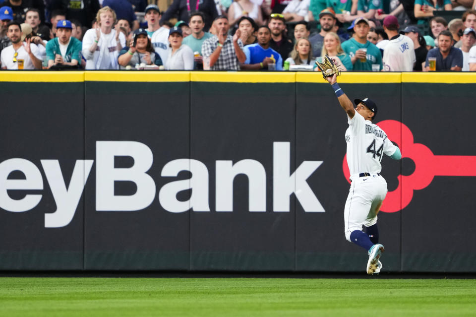 Seattle Mariners center fielder Julio Rodriguez catches an RBI sacrifice fly from Washington Nationals' Luis Garcia during the seventh inning of a baseball game Tuesday, June 27, 2023, in Seattle. (AP Photo/Lindsey Wasson)