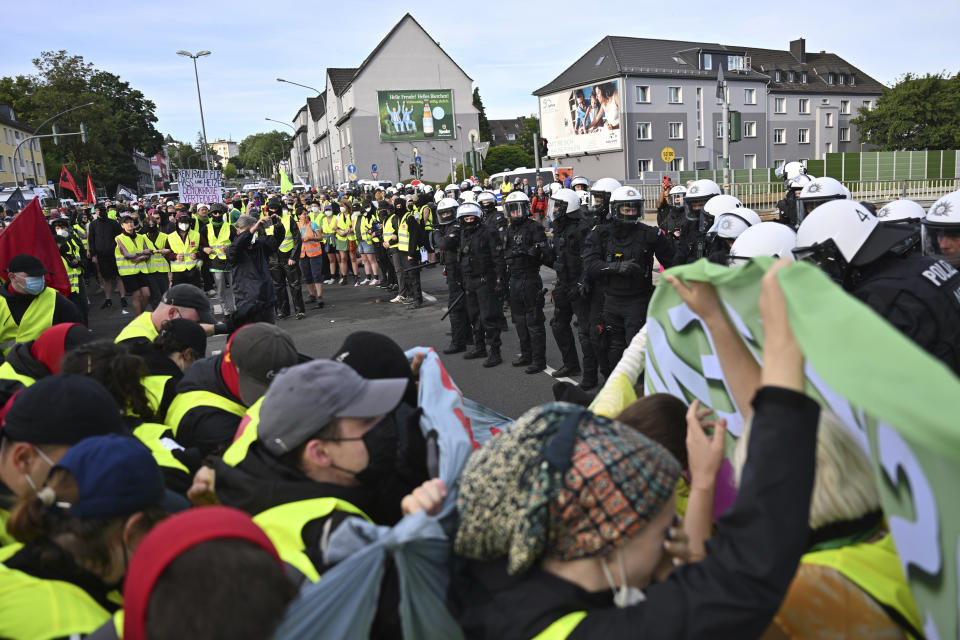 Counter-demonstrators confront the police on an access road to the grounds of the far right AfD party conference in Essen, Germany, Saturday, June 29 2024. (Henning Kaiser/dpa via AP)