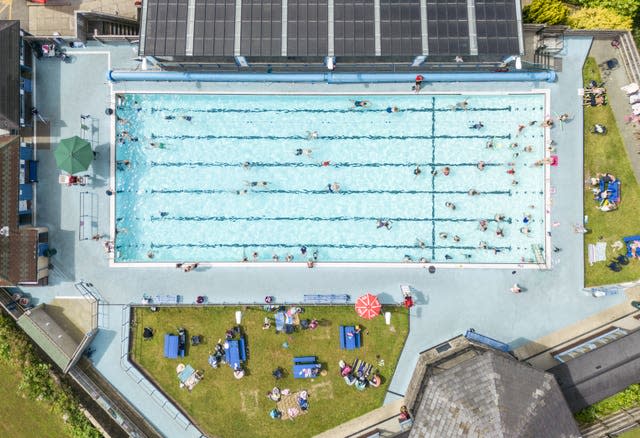 People enjoy the hot weather at Hathersage open air swimming pool at Hope Valley, near Sheffield